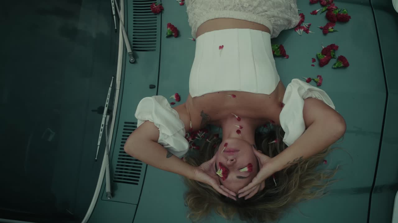 Woman on a Vintage Car with Flowers