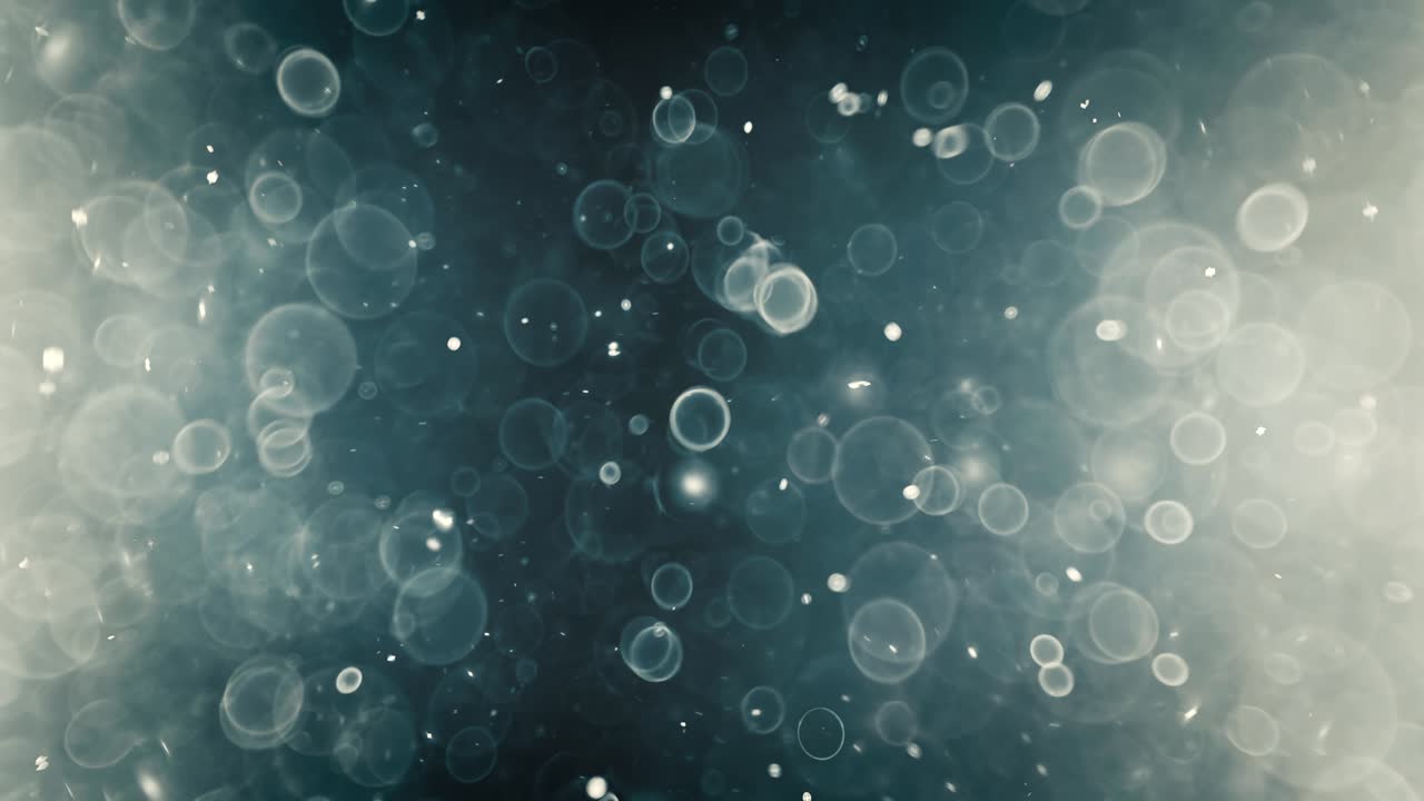 Floating abstract particle bokeh on dark background