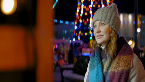 woman enjoying a festive night at a christmas market