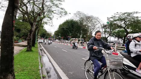 motorbikes and cars navigate a bustling street