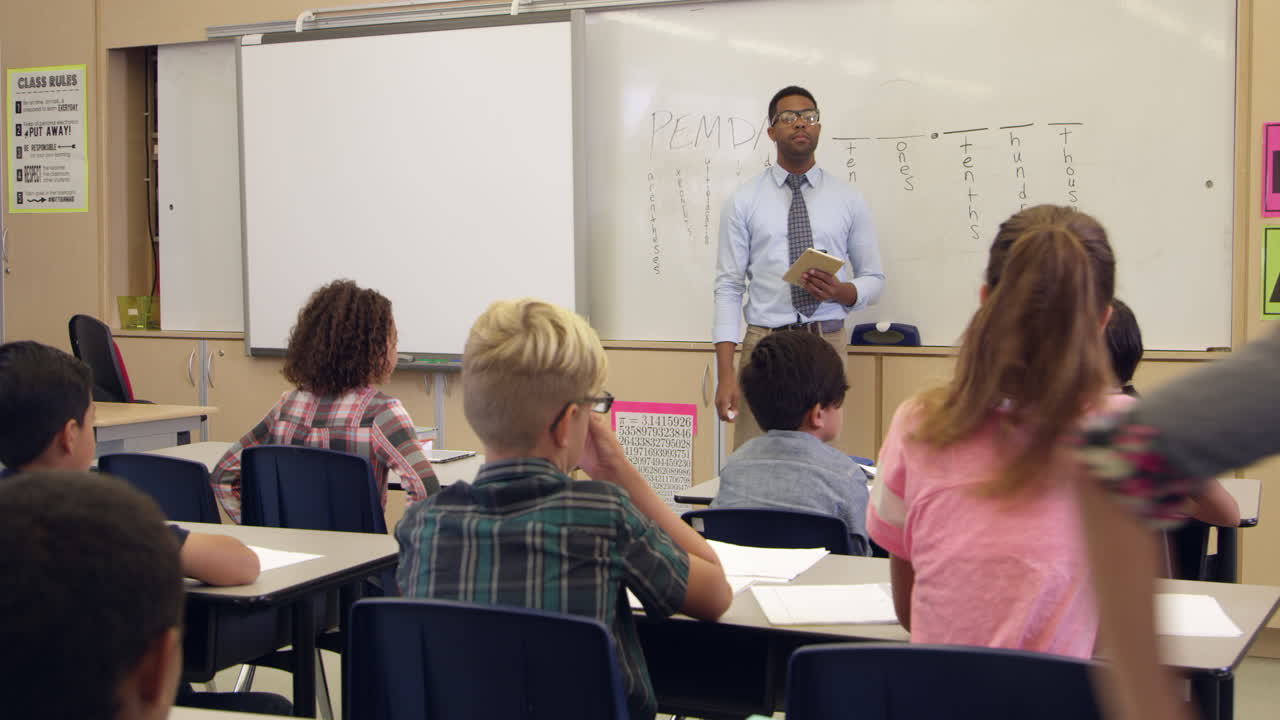 una colegiala respondiendo a una pregunta delante de la clase, filmada en r3d