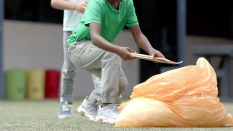 picking up trash, children cleaning school playground, promoting environmental care