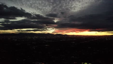 orange glowing sunset over phoenix, arizona with storm clouds overhead