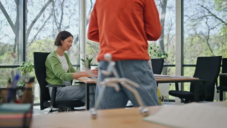 business team work computers sitting coworking. young manager bringing coffee