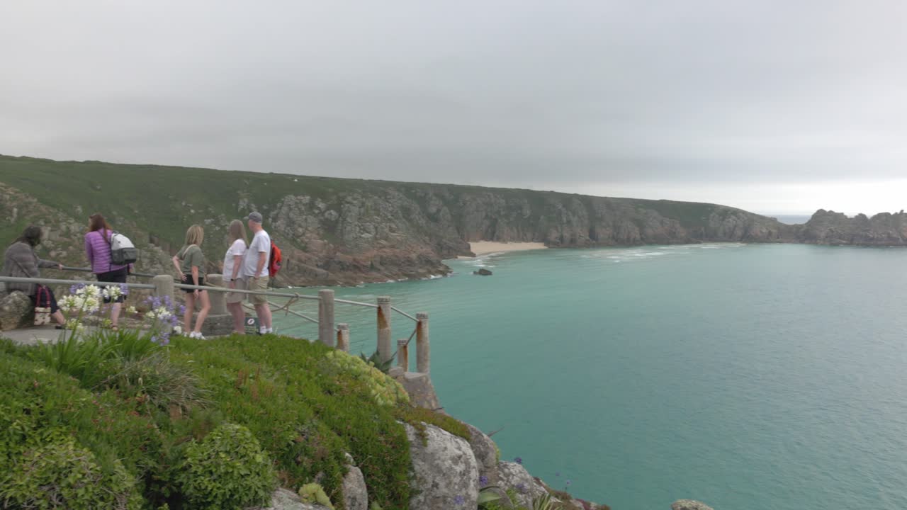 People admiring the scenic coastal view from a lookout point