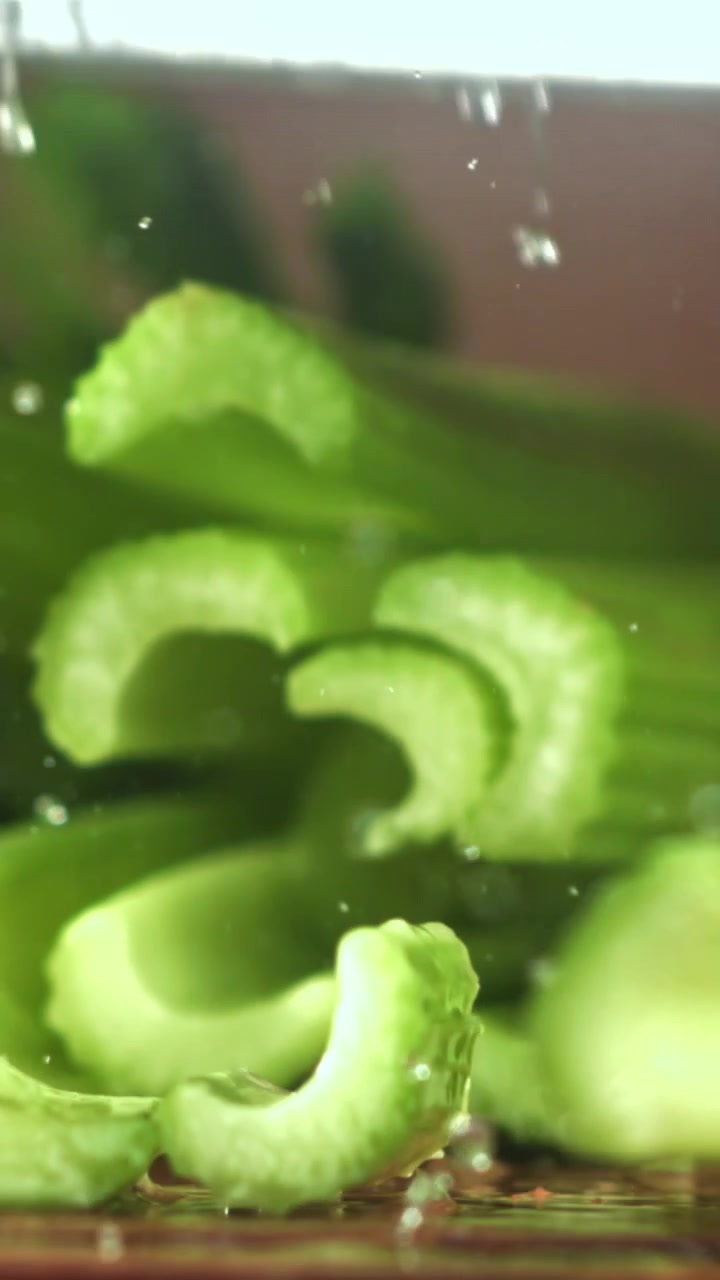 Slow Motion Chopping Fresh Green Celery with a Knife