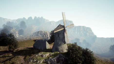 stone windmill on a foggy hilltop