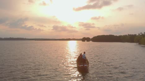 Beautiful-view-of-tourists-enjoying-canoeing-with-sunlight-reflecting-through-the-waters-of-the-sea-during-golden-hour