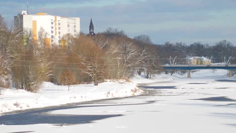 the old railway bridge over the river in winter