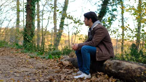 young boy waiting in forest