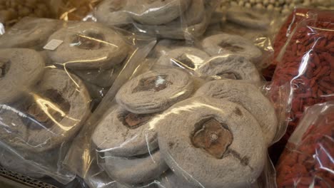 dried persimmon cake in plastic bag for sale at asian street food market documentary