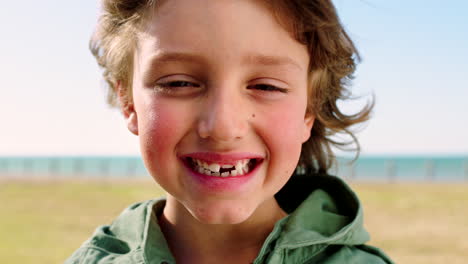 Face,-smile-and-kid-at-beach-park-on-vacation