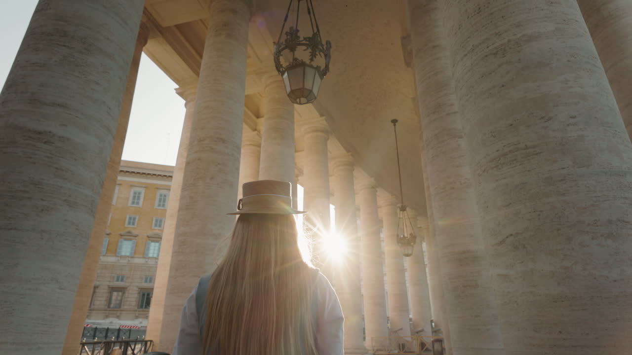 Woman walking among columns