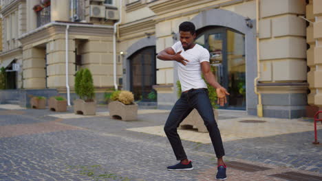 Energetic-guy-dancing-latino-dance-on-street.-Man-making-dance-elements-in-city