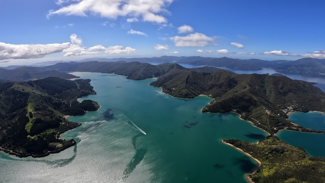 A breathtaking aerial POV shot from a helicopter soaring over the Marlborough Sounds in New Zealand.