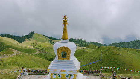 drone shot captures nepal stupa amidst green hills forest mountain landscape of sailung dolakha near tibet. this antique site is significant for trekking and tourism serene and scenic escape