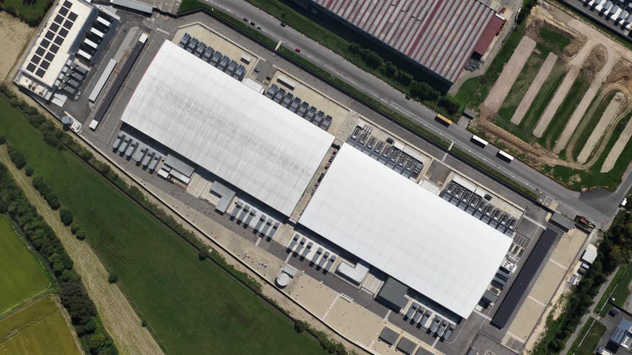 Computing center in Milan, top down view, server space, computing technology. Big data and AI infrastructure. Aerial drone video