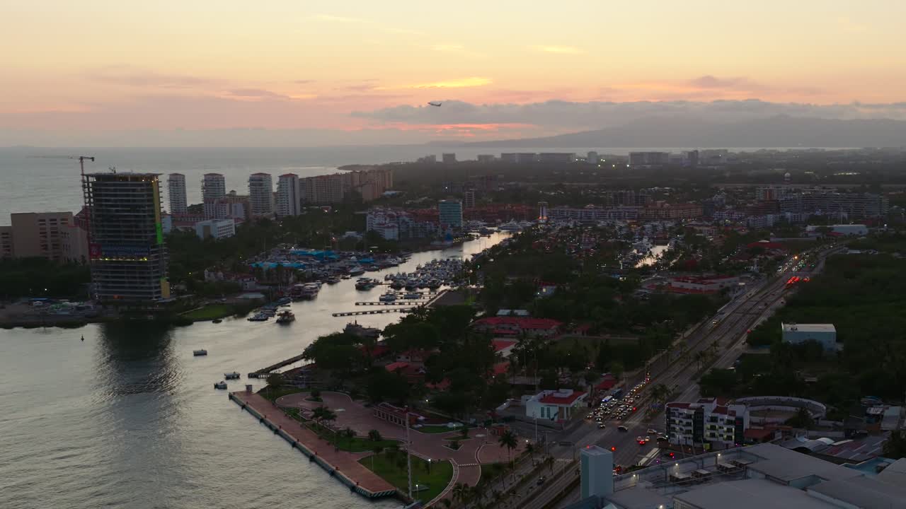 Aerial view of a coastal city at sunset