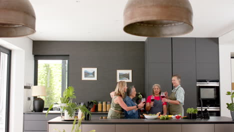 Senior diverse group of women enjoy time in a modern kitchen preparing a meal
