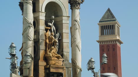 monumental fountain in plaça d'espanya with venetian tower in the distance in barcelona, spain