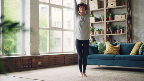 woman practicing yoga at home
