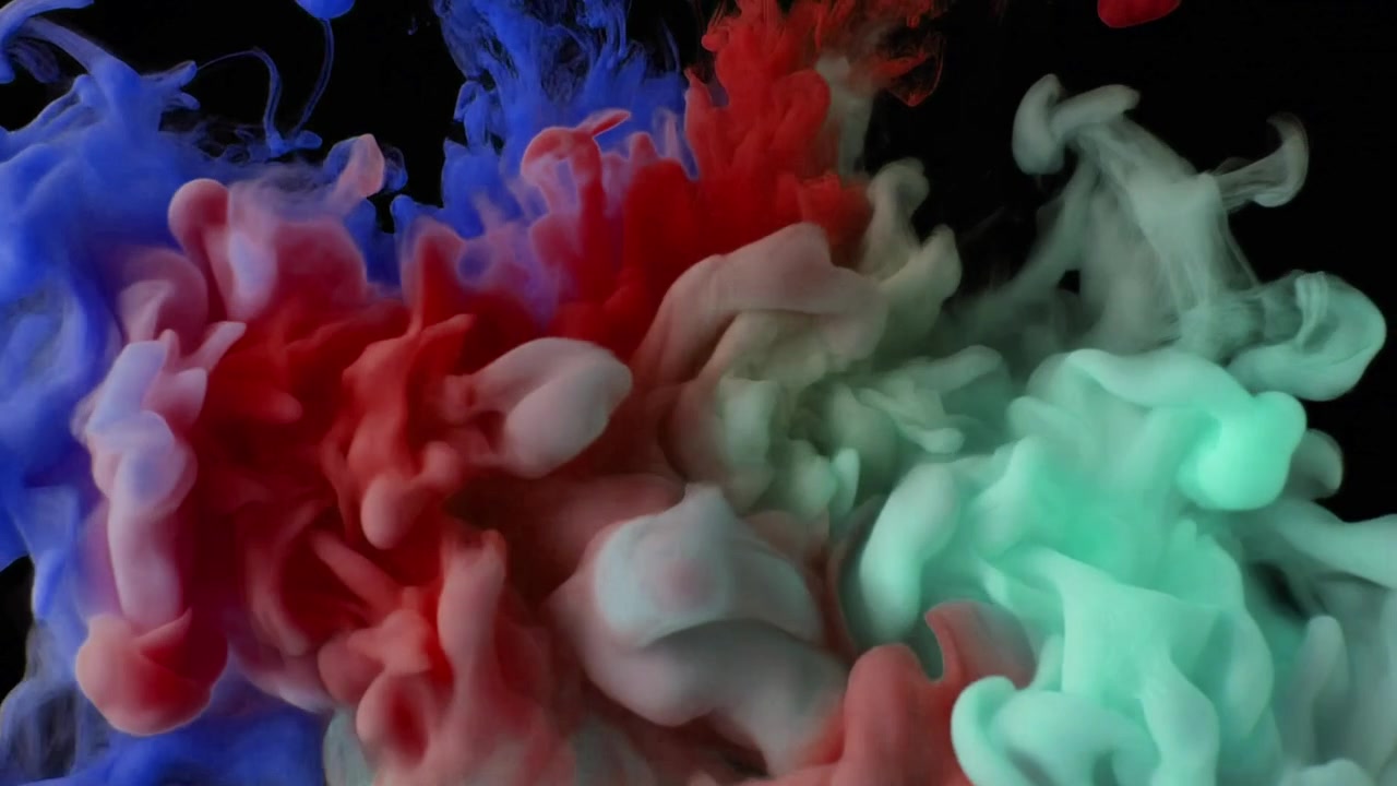 Movimento Astratto di Inchiostro Blu, Rosso e Verde che Vortica nell'Acqua