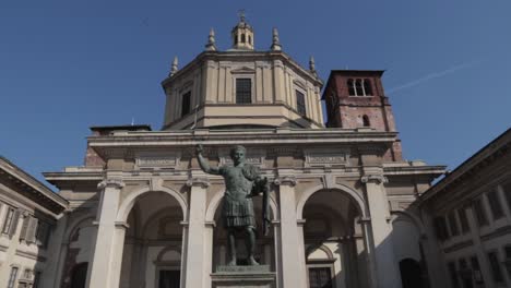 statue of emperor constantine in front of church in milan, italy