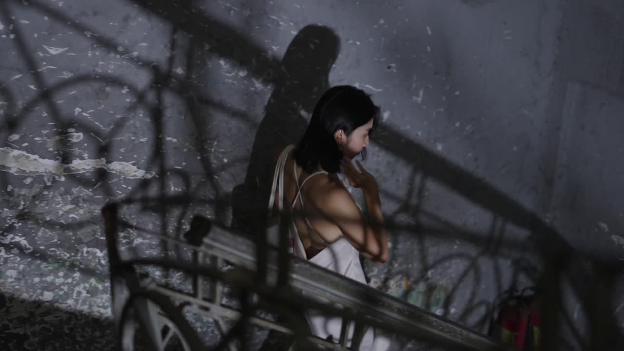 Woman in a White Dress on a Staircase