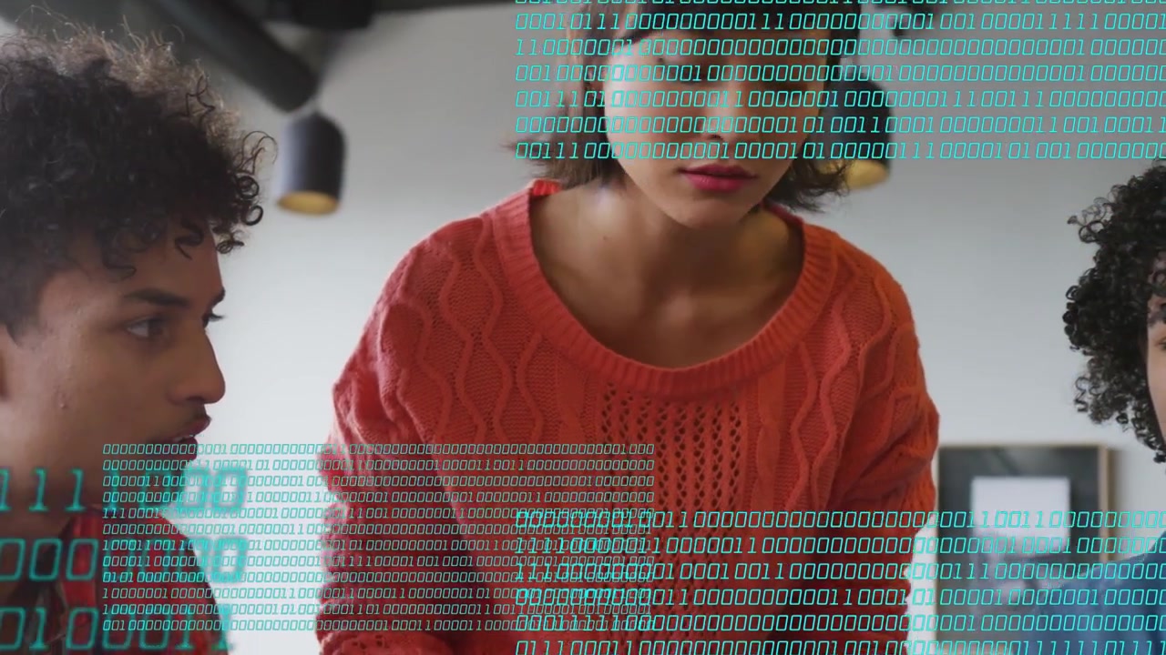 Woman leaning over laptop as binary overlay appearing, pointing green pen guiding team through tech