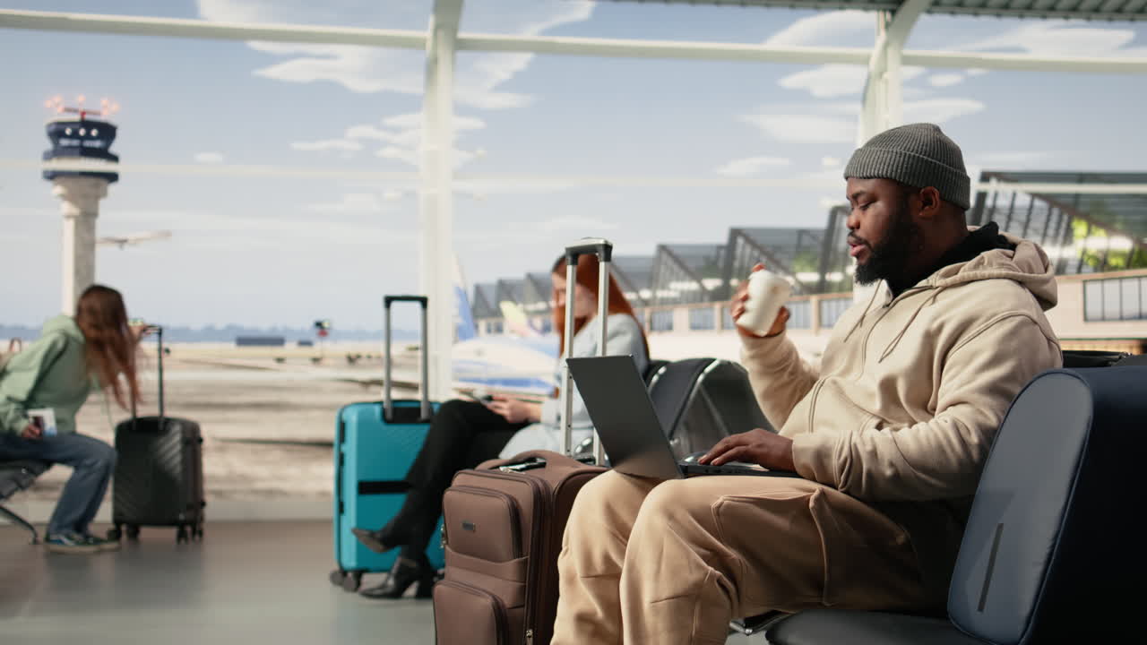 Digital nomad man, working online with laptop, in international airport terminal