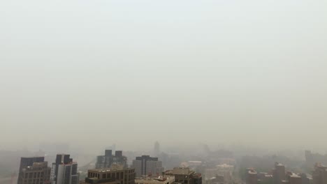 aerial view away from a condo in a smoke fog covered bronx, new york city, usa