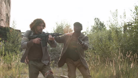 men with guns around an abandoned house