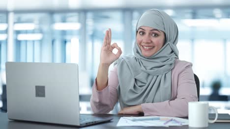 happy muslim businesswoman okay sign