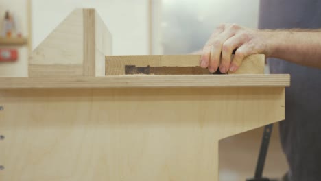 carpenter cutting recess in white oak slab on router table