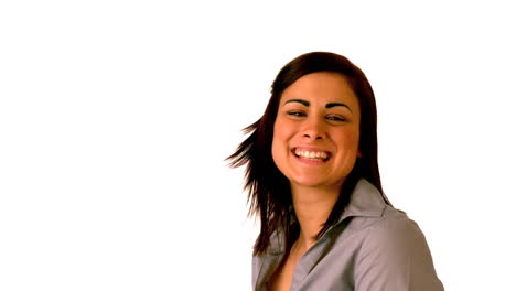 Happy-brunette-tossing-her-hair-on-white-background