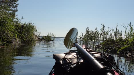 first person view, canoe in river approaching large body of water