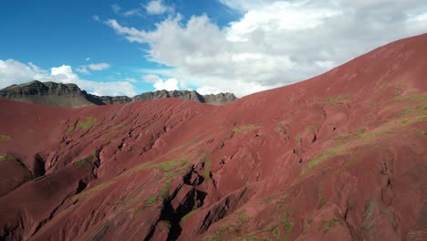 majestic drone shot of rainbow mountain region. red valley reveals otherworldly landscapes and vibrant earth tones in the andes