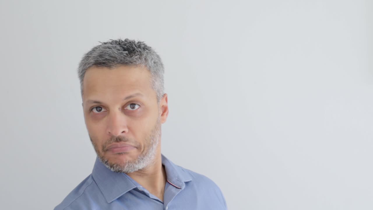 Man Waving and Smiling, Then Looking Confused on White Background