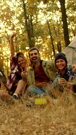 happy friends camping in the woods