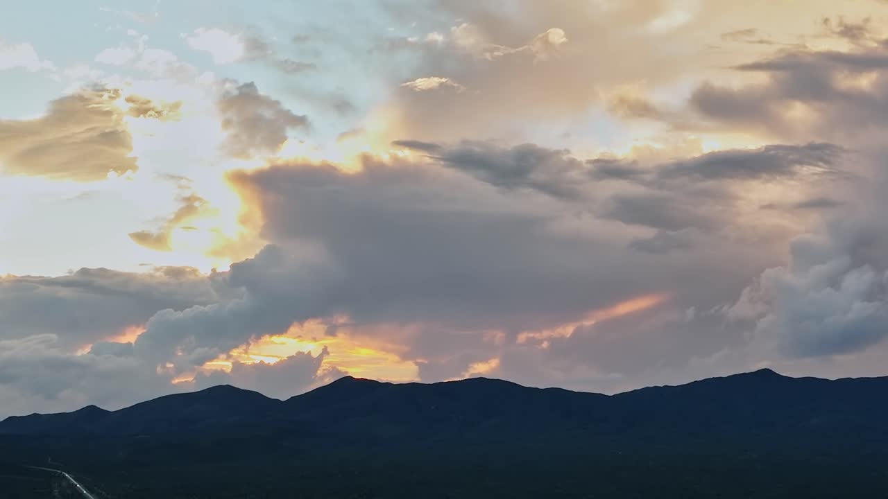 Clouds gather over mountains under the sunset in the USA