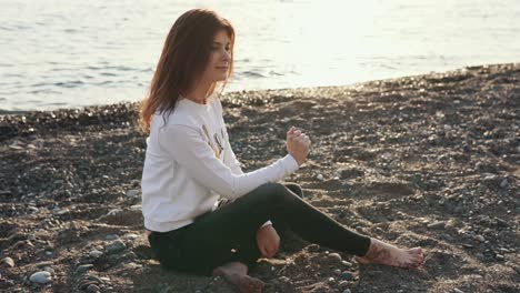 woman relaxing on a beach at sunset