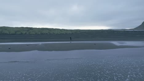persona caminando en la playa de stokksnes en islandia