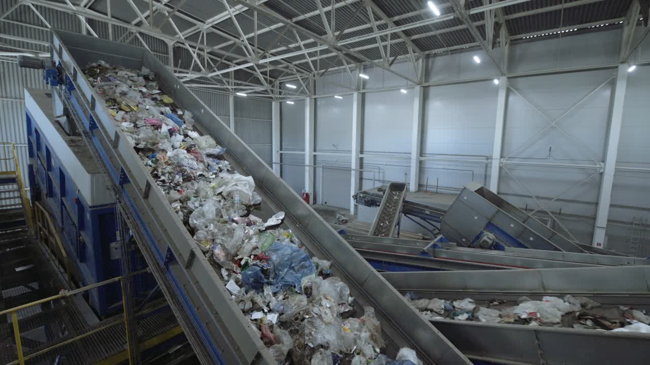 Waste sorting plant conveyors filled with various household waste