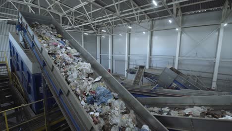 waste sorting plant conveyors filled with various household waste