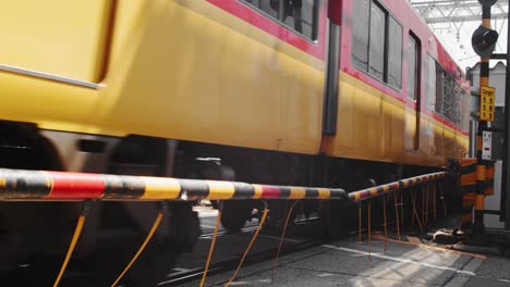 Shot-of-a-train-running-through-a-city-in-Kyoto,-Japan-4K