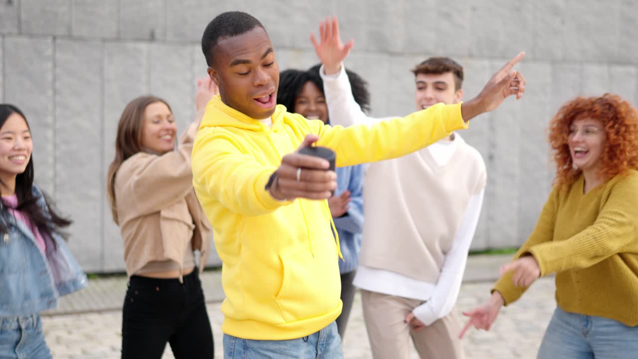 Multi-ethnic happy friends dancing excited in the city