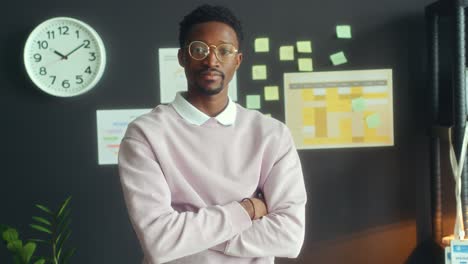 portrait of african american businessman smiling at camera in office