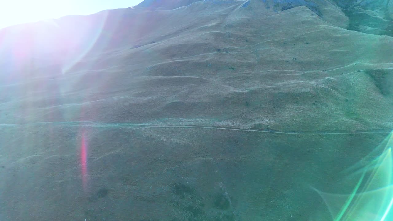 Aerial footage captures Queenstown's Moke Lake mountains, showcasing vibrant landscapes and dynamic lighting transitions over 31 seconds