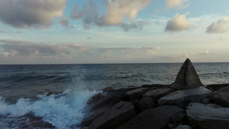 Pyramid-shaped-rock-on-breakwater-of-Varazze-town-in-Italy