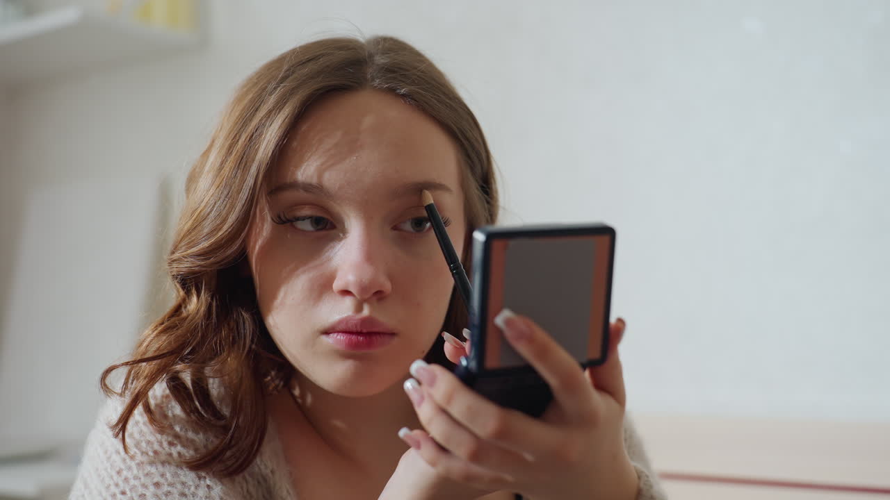 Closeup Of Woman Using Mascara In Natural Light, Young Woman Carefully Applying Mascara With Calm Demeanor, Female Patient In Cozy Setting Gently Applying Mascara To Her Lashes For Daily Wear